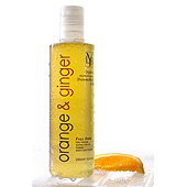 Orange and ginger bath oil beside a slice of orange.